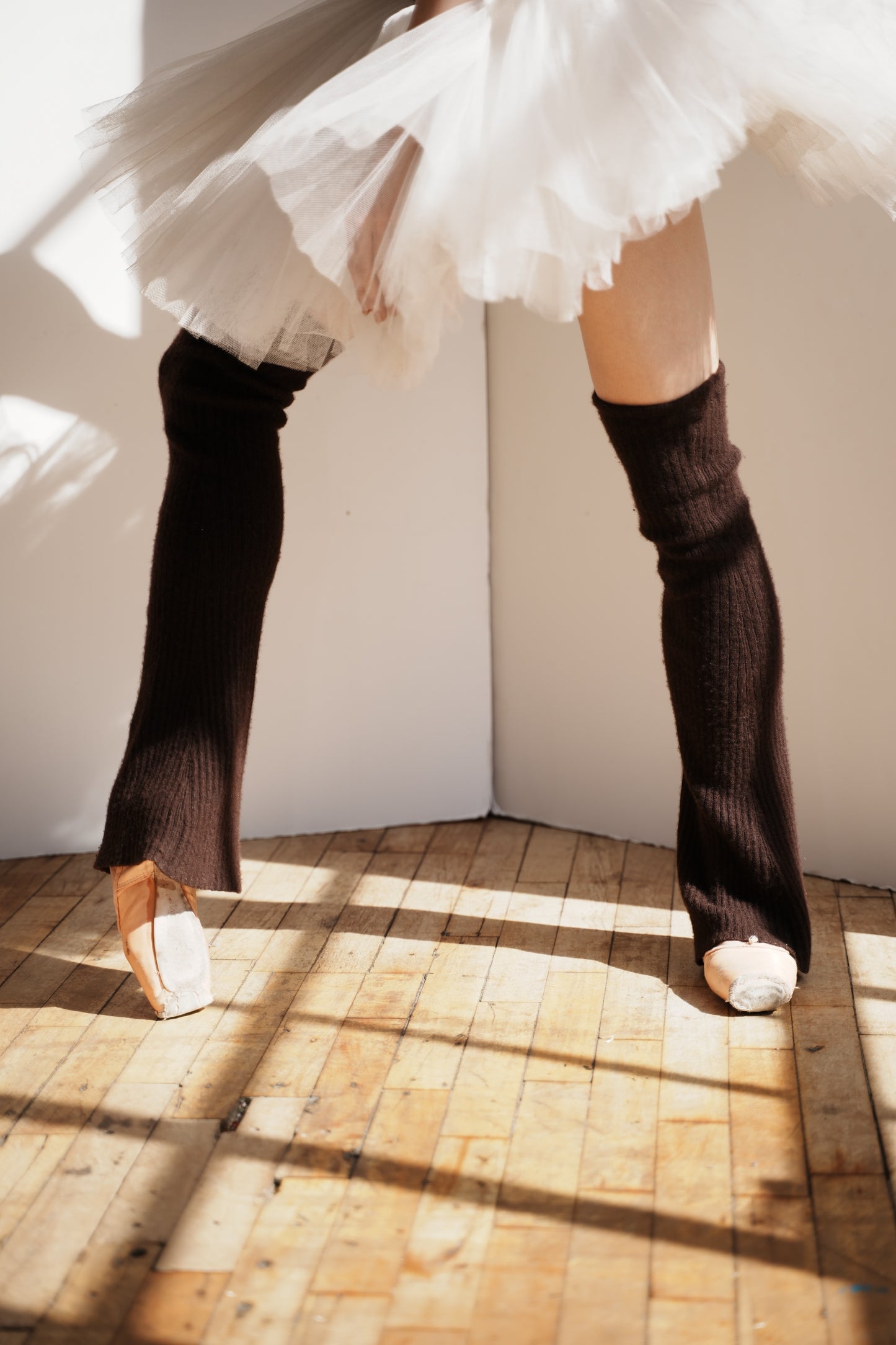 Ballet dancer wearing espresso cashmere legwarmers