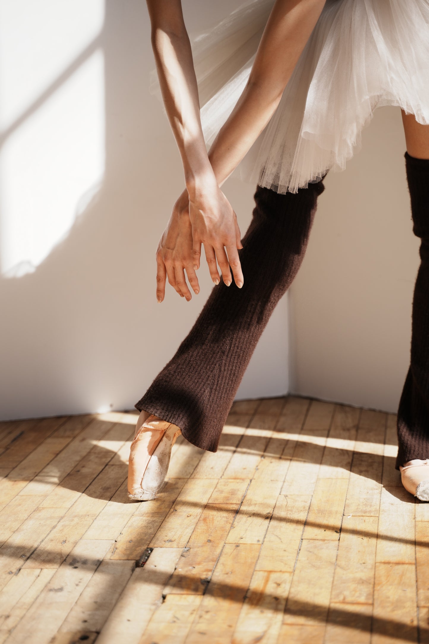 Ballet dancer wearing espresso cashmere legwarmers
